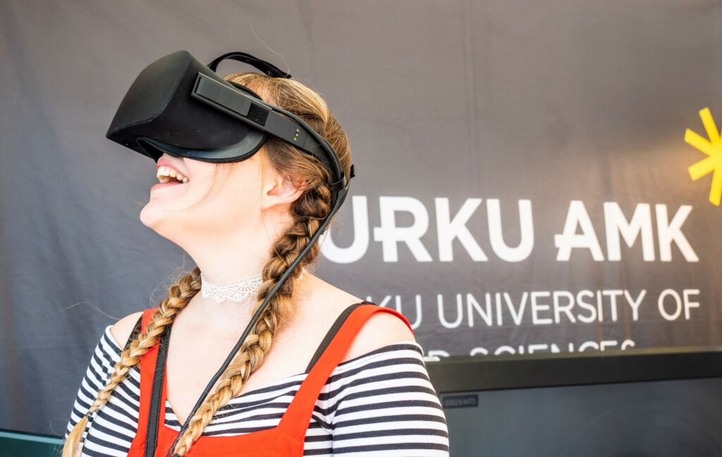 person wearing VR glasses, Turku UAS logo